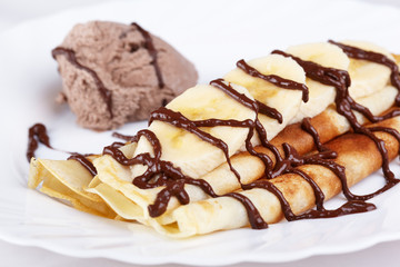 Thin pancakes with banana and ice cream