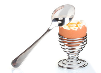 boiled egg in metal stand and spoon isolated on white
