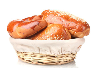 Baked bread in basket isolated on white