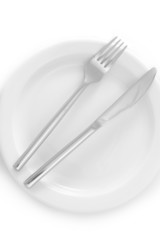 White empty plate with fork and knife isolated on white