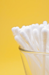 Cotton buds yellow background