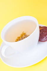 Cup of green tea on the saucer and cookies