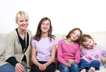 Obraz premium Family sitting in living room on sofa