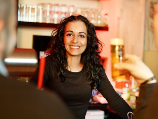 Pretty mediterranean looking bar-maid loves her job