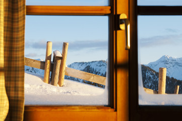 view through window of a hut with very much snow