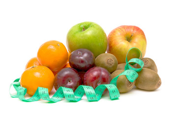 Fruits and measuring tape on white background