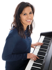 smiling teenage girl playing piano