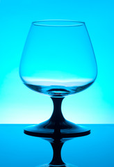 Brandy glass isolated on blue background