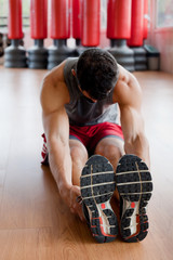 Muscular man stretching