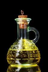 olive oil and olives on yellow background