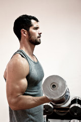 Handsome man lifting weights