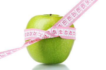 green apple and measuring tape isolated on white