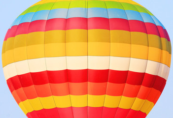 close up of colorful hot air balloon isolated on blue sky