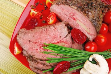 hot ham on red dish over wooden table