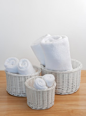 Clean towels in white wicker baskets