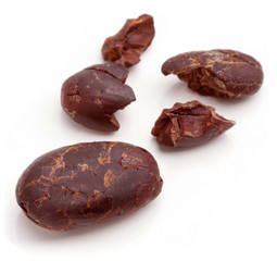Raw cacao beans peeled isolated on white background.