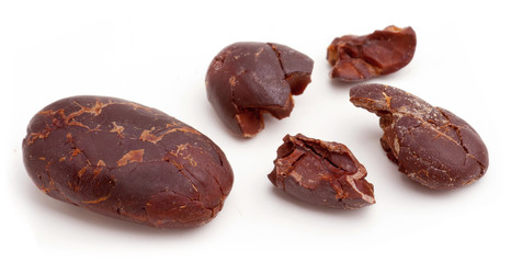 Raw cacao beans peeled isolated on white background.