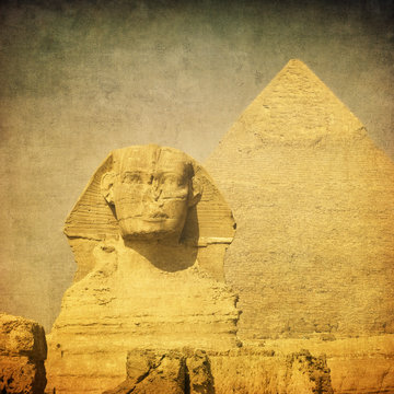 grunge image of sphynx and pyramid
