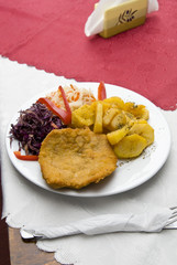 Pork chops with potatoes and salad at the bar