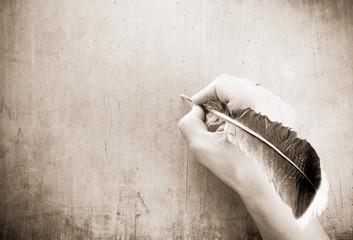 writing hand and pen on wood