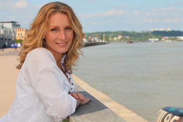 Relaxed woman leaning out over the river