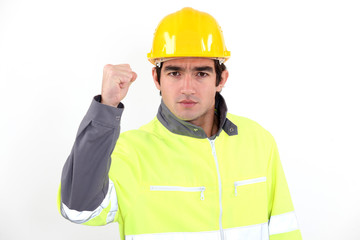 Angry builder waving fist