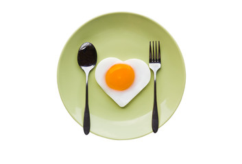 Fried egg heart and spoon