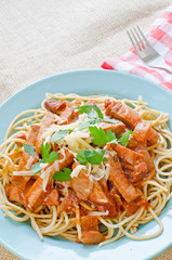 Spaghetti with ham and tomato sauce