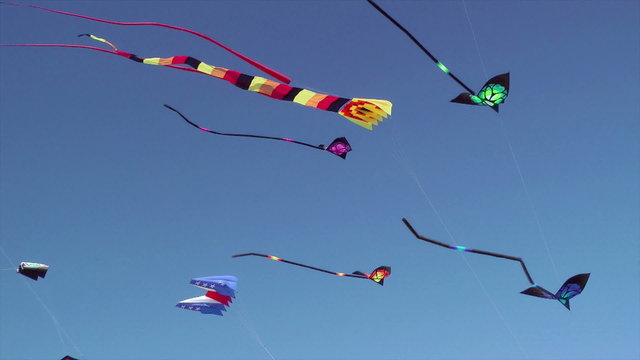 Kites flying against blue sky