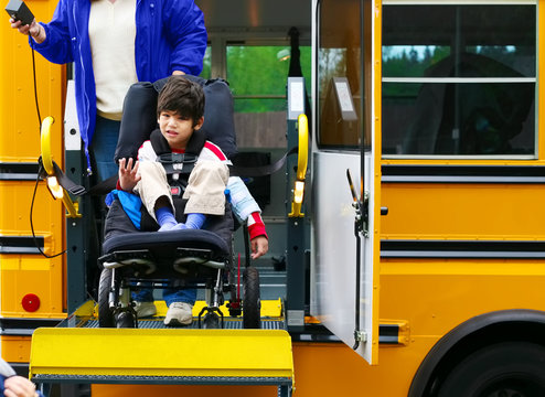 Disabled five year old boy using a bus lift for his wheelchair