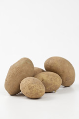 Raw potatoes in burlap bag isolated