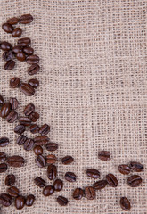 Dark roast coffee beans on burlap