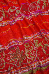red scarf with white interwoven ornament