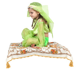 little arabian girl sitting on a flying carpet