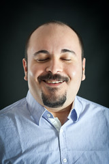 Happy man on dark background.