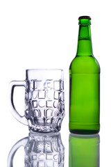 A bottle of beer and an empty beer mug