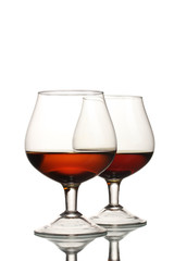 Two glasses of cognac isolated on white