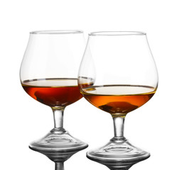 Two glasses of cognac on grey background