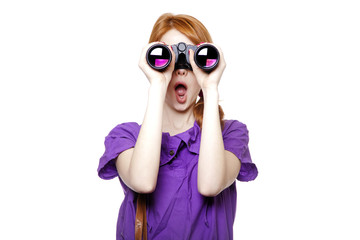 Teen redhead girl with binoculars isolated on white background