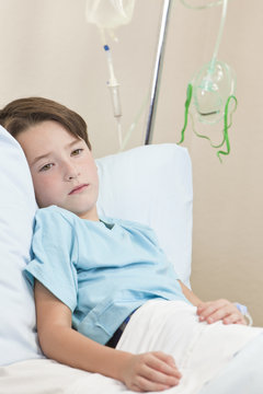 Young Boy Child Patient In Hospital Bed