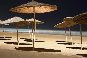Umbrellas at a beach at night