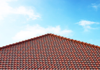 Naklejka premium brick roof with clear cloud blue sky