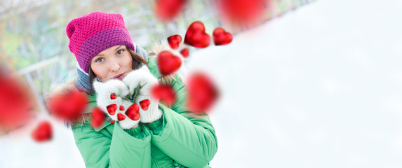 Happy girl thinking of love and having fun outdoors in winter