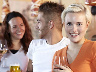 Two pretty girls and a young man having fun in a bar