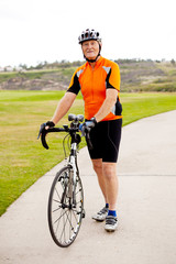 senior man standing by his road bicycle