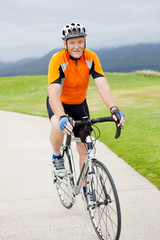 happy active senior man riding bicycle