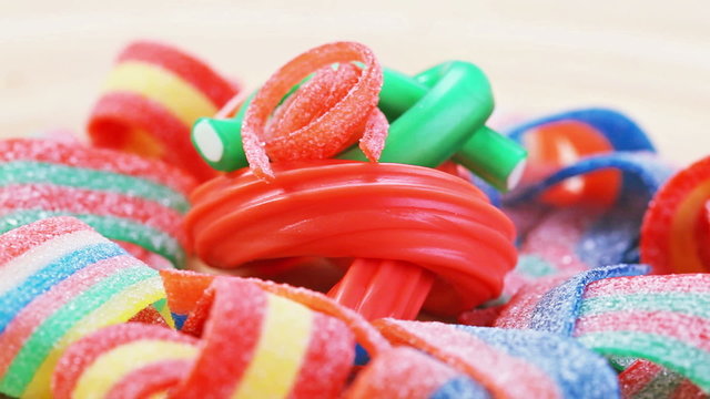 Colorful gummy candy (licorice) rotating sweets background