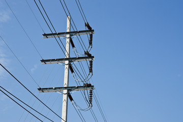 electricity post with blue sky