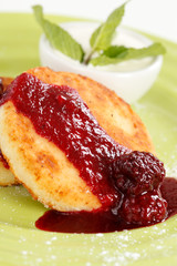 Cheese pancakes with sour cream and jam