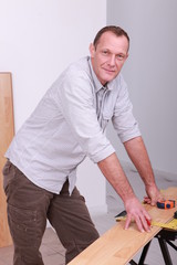 craftsman measuring a wooden board